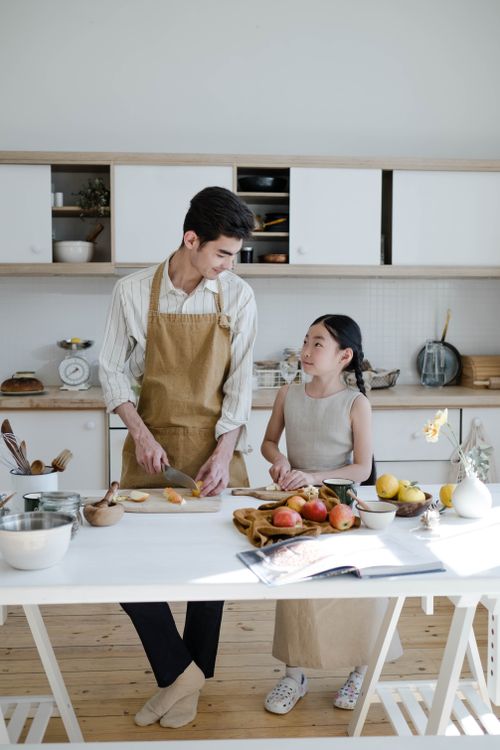 Free A father and daughter enjoy baking together in a modern kitchen. Stock Photo