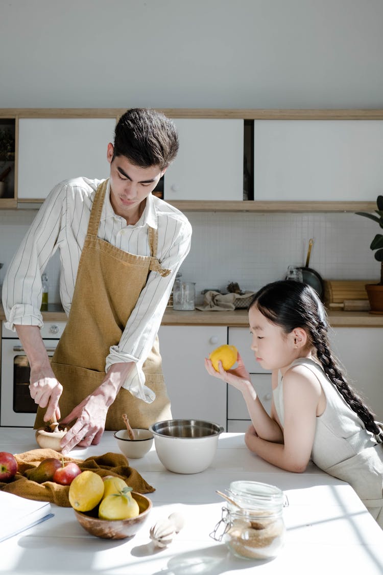 A Man Cooking With His Daughter