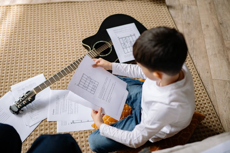 Boy Reading A Music Sheet