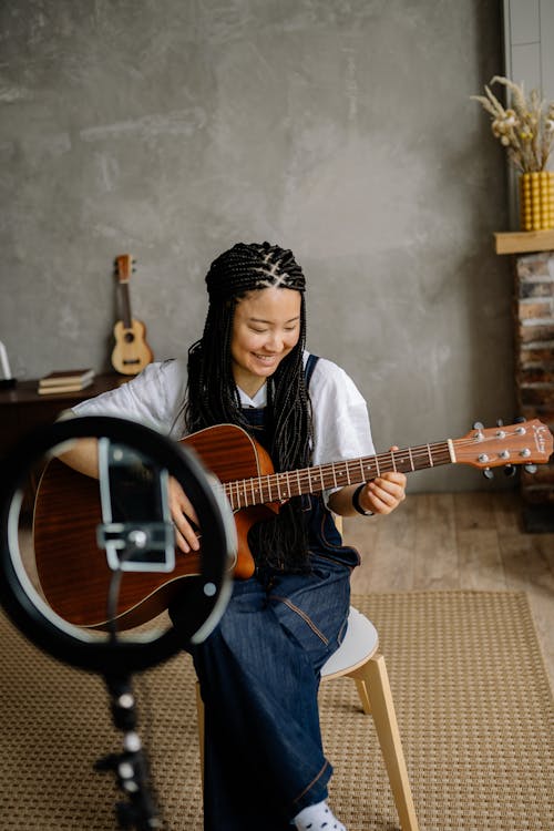 A Woman Playing Acoustic Guitar