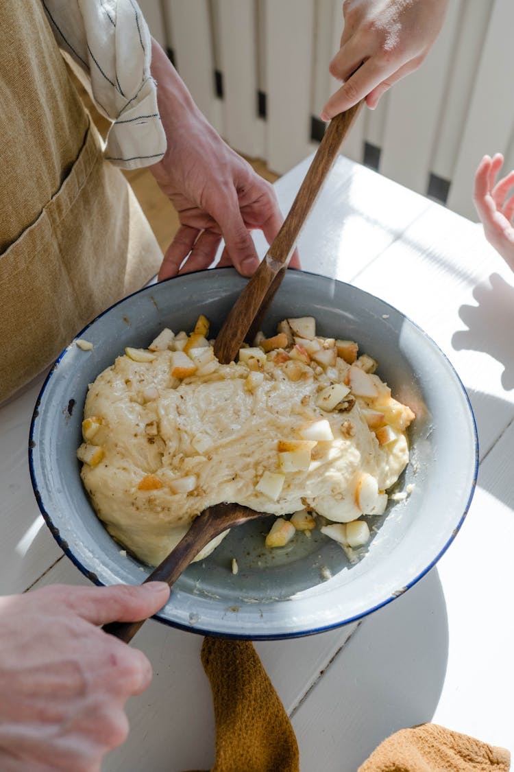 A Bowl Of Dough And Sliced Apples 