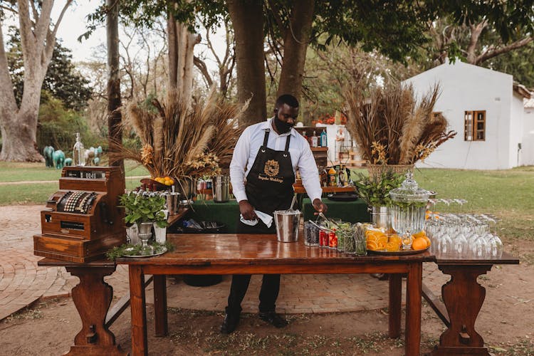 Man Serving Fruit Drinks In A Garden