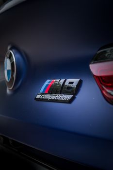 Close-up of a sleek blue luxury sports car with a recognizable brand emblem. 8190581