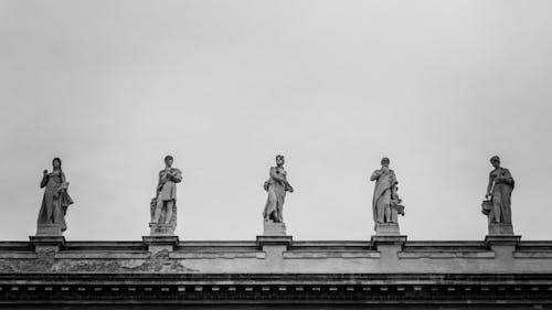 Free Grayscale Photography of Statues on Roof Stock Photo