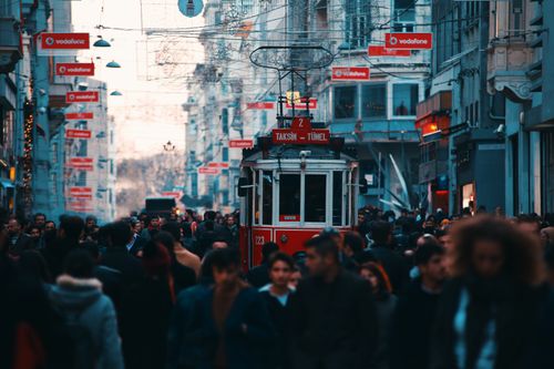 Free A bustling street in Istanbul featuring a historic red tram amidst a lively crowd. Perfect travel destination inspiration. Stock Photo