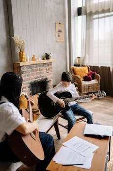 A mother teaching her young son to play guitar in a cozy living room setting.