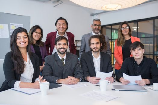 A multicultural business team collaborating in a modern office meeting room.