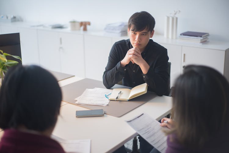 A Group Of People Having A Meeting In The Office