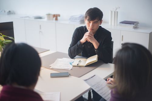 Free Focused business team in discussion during a meeting in a contemporary office environment. Stock Photo