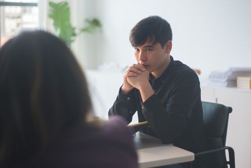 Free Young professionals engaged in a serious business discussion in a modern office. Stock Photo