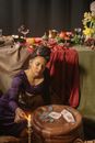 Woman in Purple Long Sleeve Dress Sitting on Chair