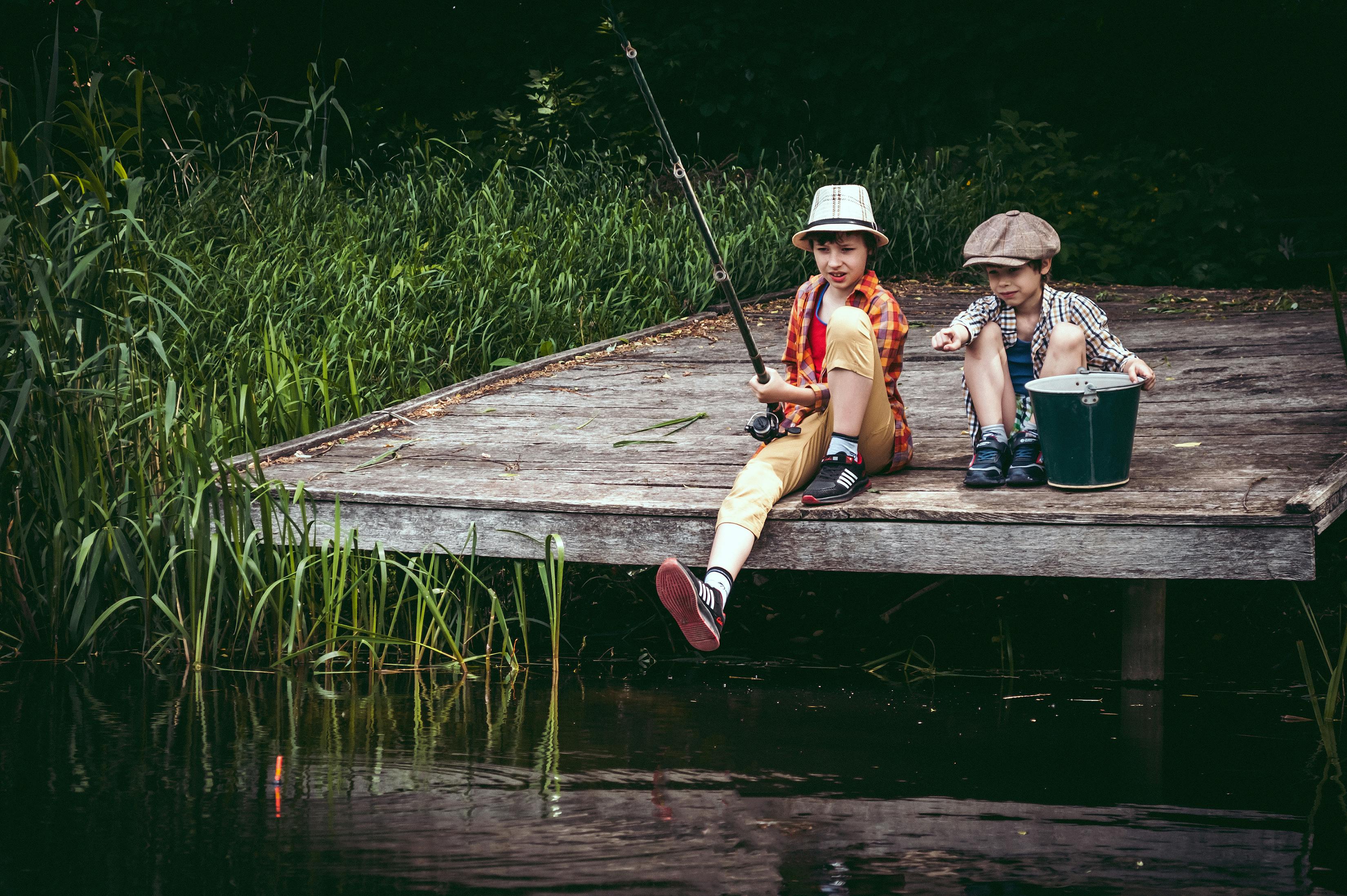 Boys Fishing from a Wooden Deck · Free Stock Photo