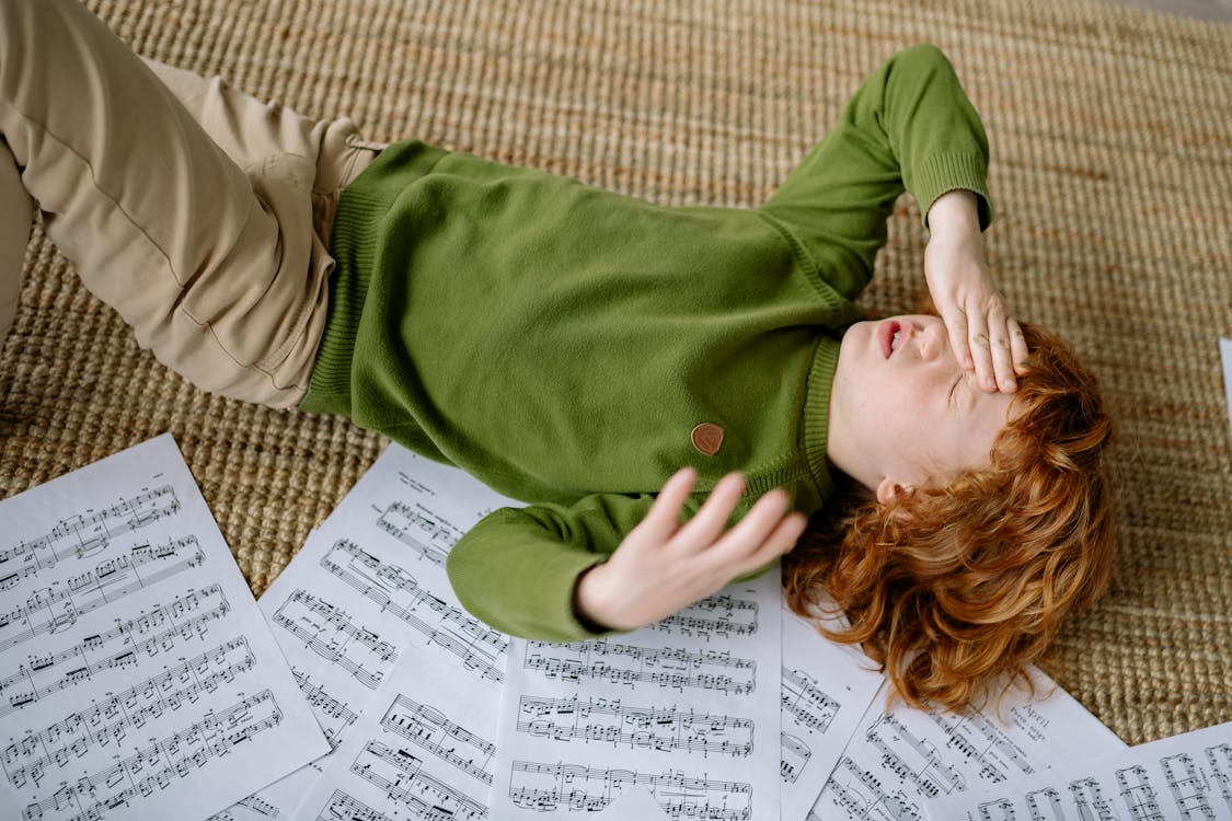 Free A Child with a Headache Lying on the Rug Stock Photo