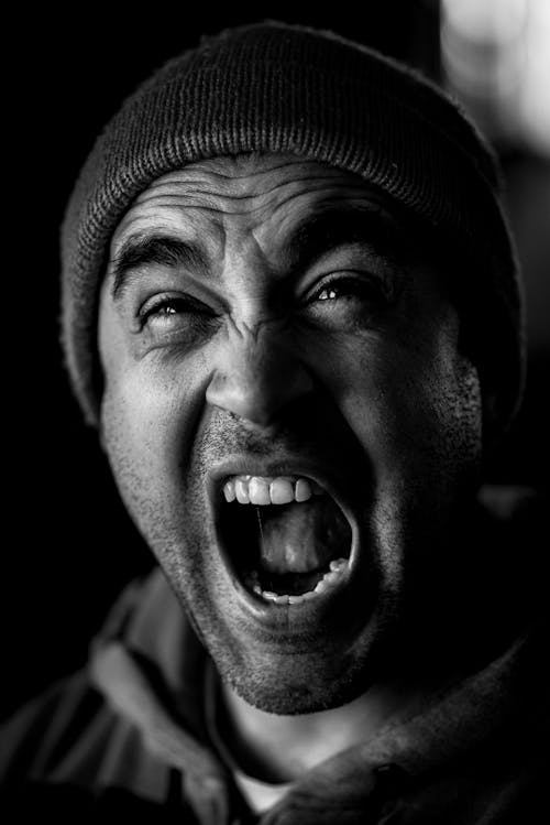 Free Man in a Knitted Beanie Screaming Stock Photo
