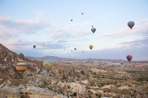 Hot Air Balloons Flying Over the Mountains