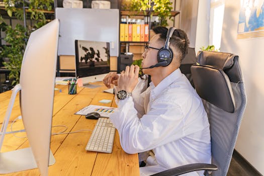 Business professional working with headset in a modern office setting.