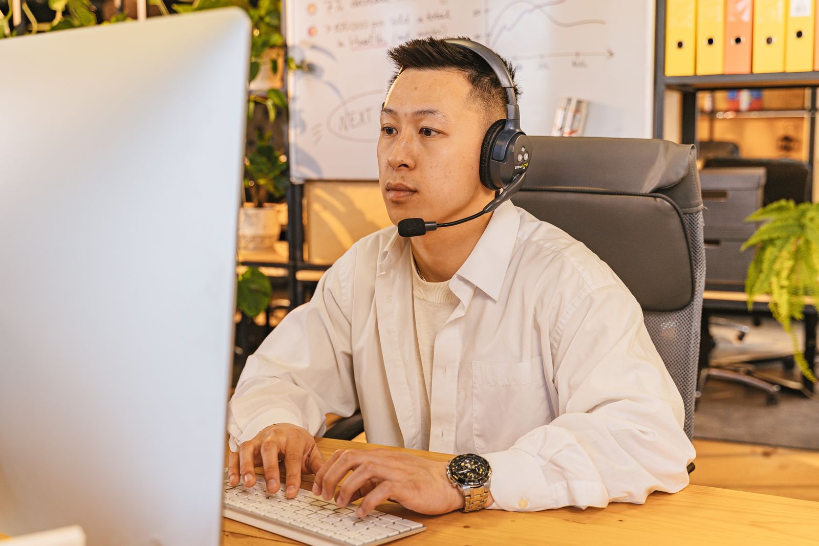 Office professional using a headset for an on-demand phone conversation