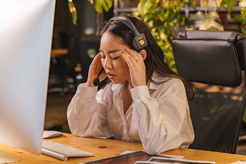 Free Tired Woman at a Desk in an Office  Stock Photo