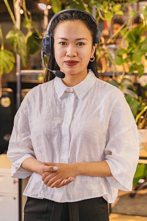 Portrait of a Woman Wearing a Headset with a Microphone in an Office