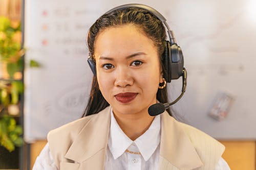 Woman in White Blazer Wearing Black Headphones