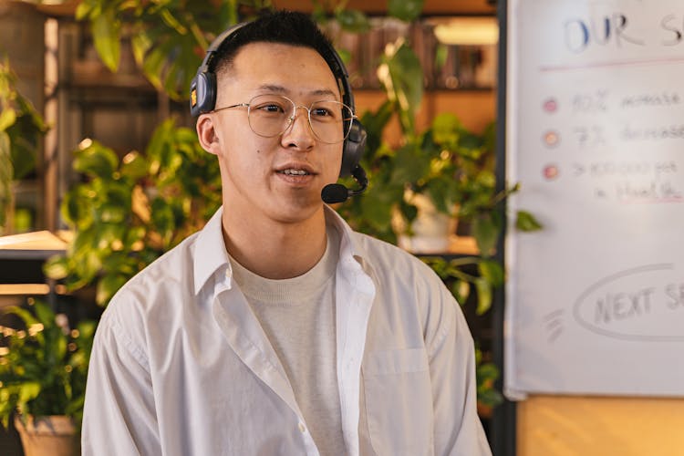 Portrait Of A Man Wearing A Headset With A Microphone On A Business Meeting 