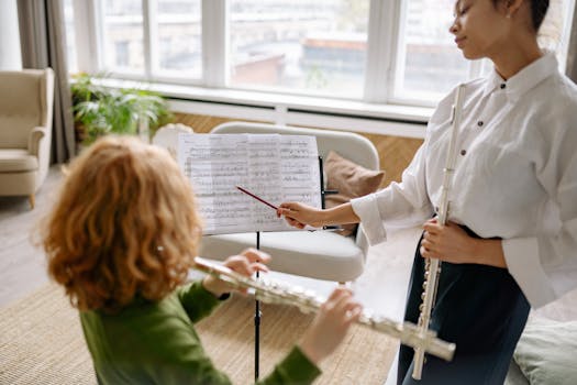 Music teacher instructing a child during a flute lesson in a cozy indoor setting.