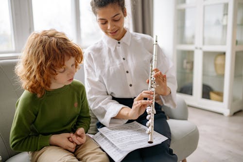 Free Woman Showing a Child a Flute Stock Photo