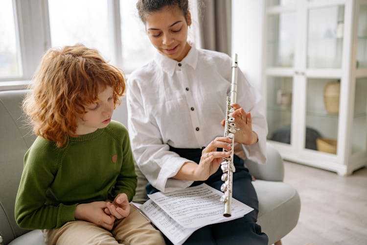 Woman Showing A Child A Flute