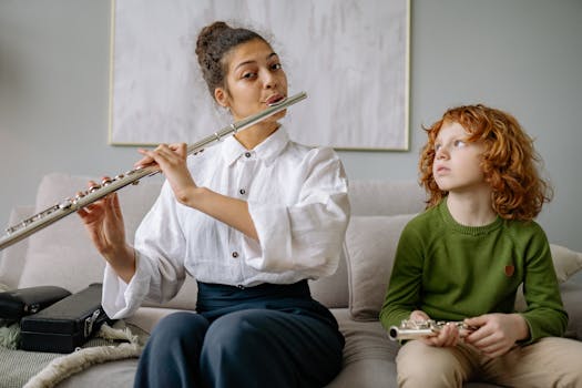 A woman teaches a boy flute lessons at home, focusing on musical instruction.
