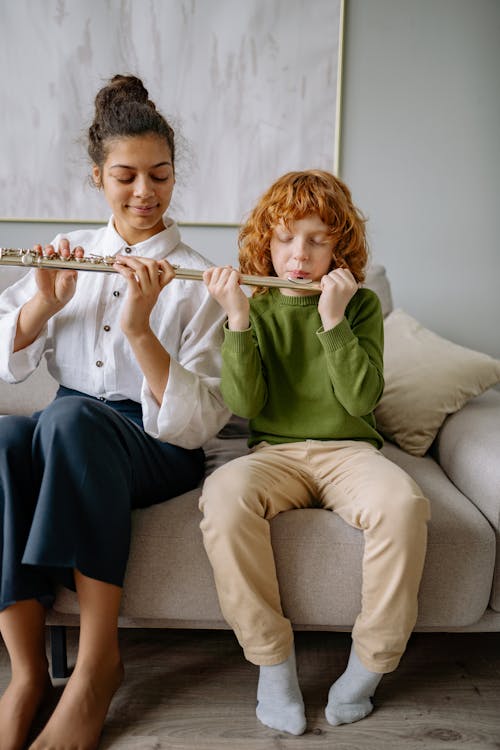 Free A Young Boy Learning how to use Flute Stock Photo