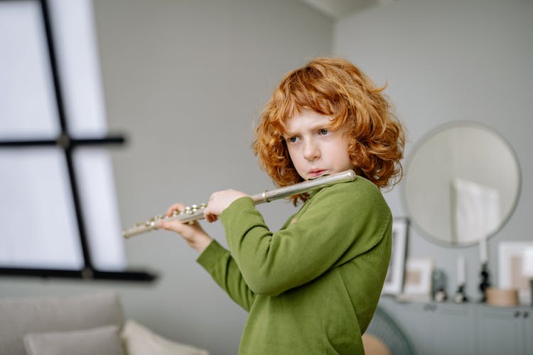 A Boy Playing The Flute 