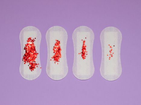 Red Sequence on Sanitary Pads on a Purple Surface
