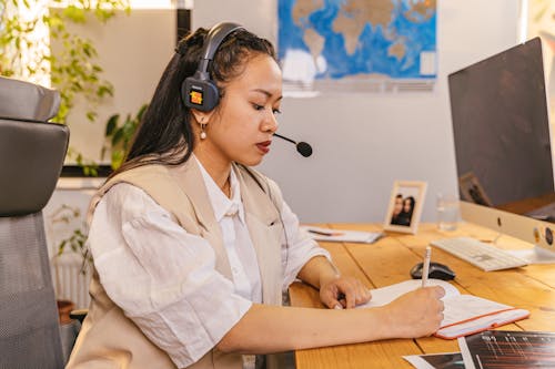 Portrait of a Woman Wearing a Headset with a Microphone in an Office