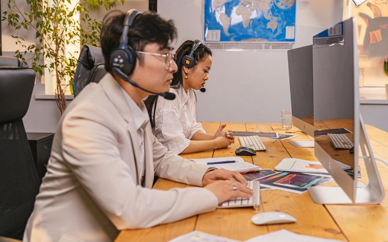 A support engineer taking a call at their desk