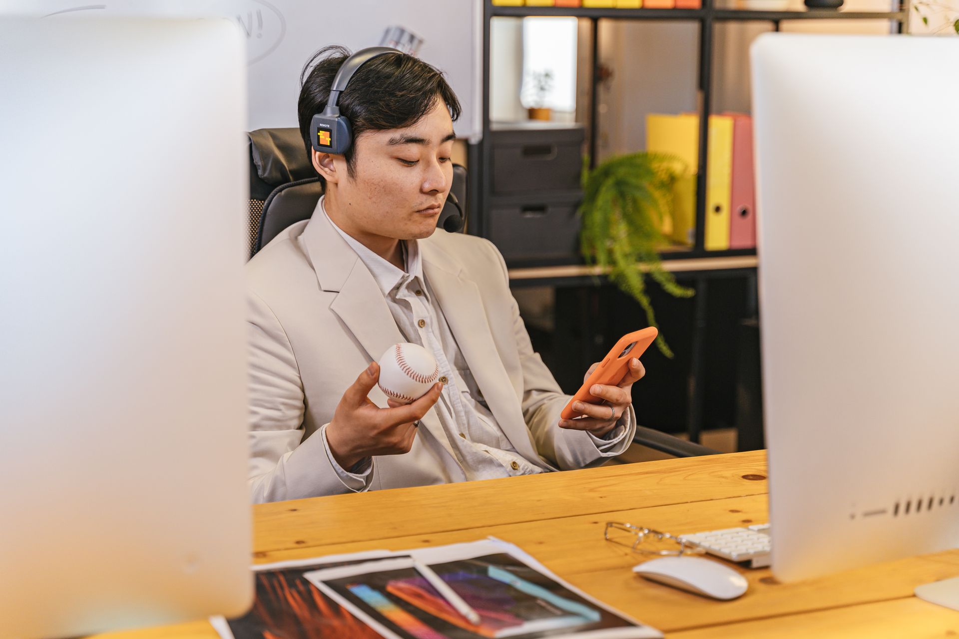 A Man in Beige Suit Holding a Smartphone