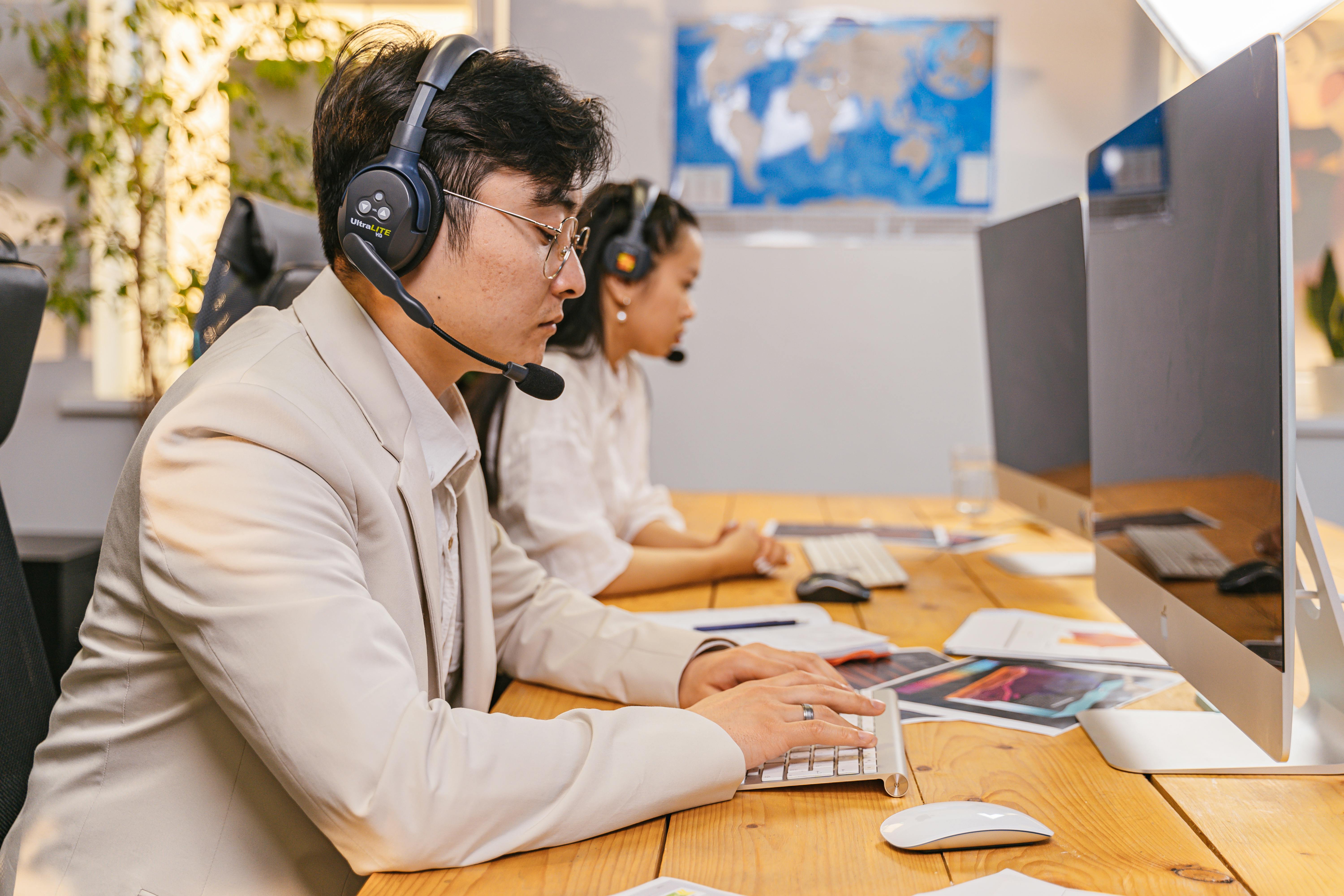 Poorly Lit Office Workspace With Isolated Desk Far From Team Members