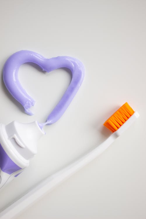 A Toothbrush and Toothpaste on a White Background