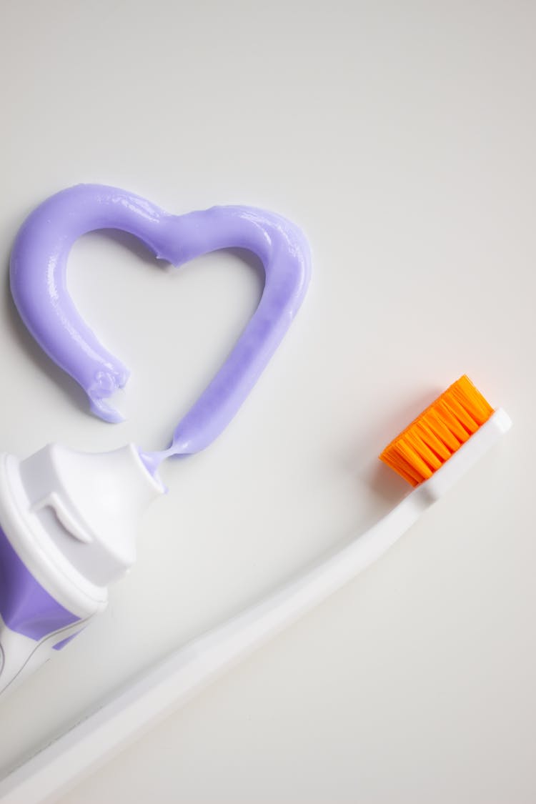 A Toothbrush And Toothpaste On A White Background