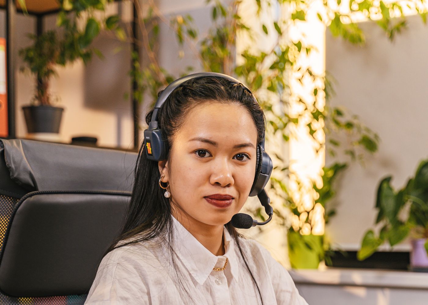 A Filipino BPO professional wearing a headset, trained for AI-enabled roles