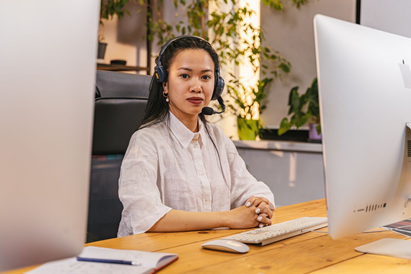 Remote English teacher wearing a headset with microphone preparing for an online teaching interview