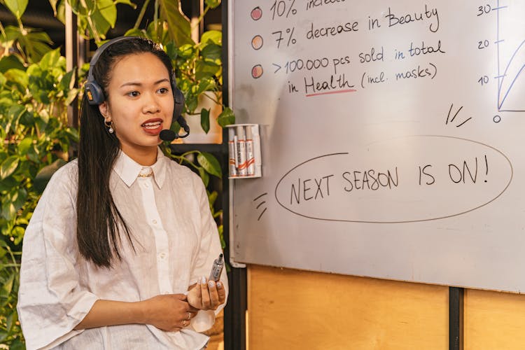 Woman Wearing A Headset With A Microphone On A Business Meeting 