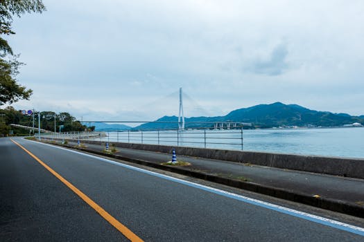 Beautiful road view by the Onomichi coastline with a majestic bridge in Hiroshima, Japan.