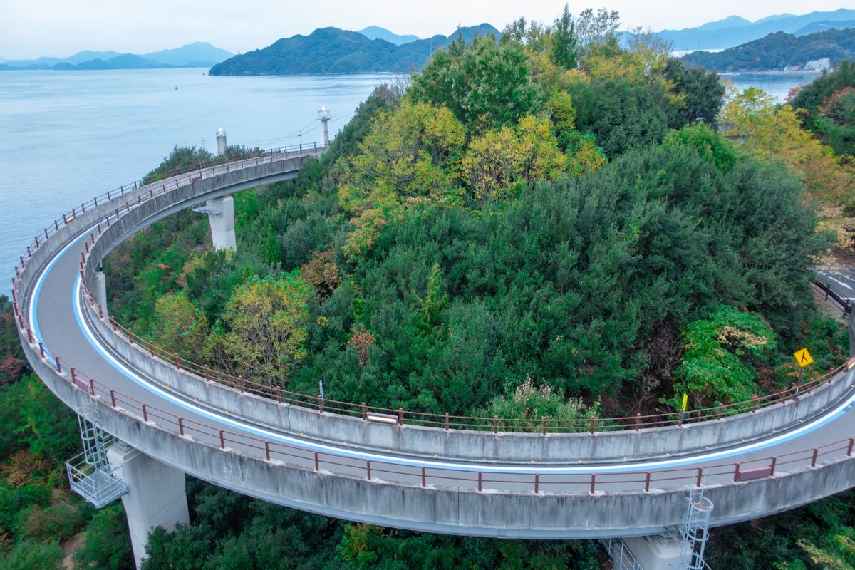 The Shimanami Kaido cycling route over the Seto Inland Sea — the spiral approach bridge at Innoshima connects Hiroshima Prefecture's island chain to Ehime