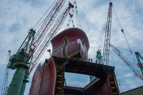 Low Angle Shot of Cranes in a Shipyard