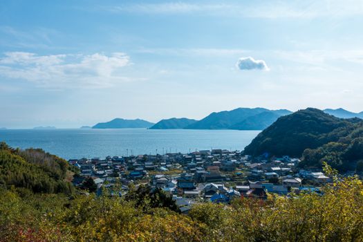 Panoramic view of Onomichi, Japan, with lush greenery and the Seto Inland Sea, showcasing natural beauty.