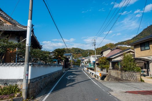 Explore a tranquil street in Onomichi, Hiroshima Prefecture, capturing traditional Japanese architecture.