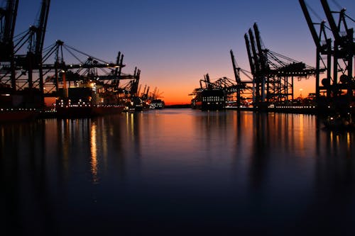 Port with Rows of Cranes at Dusk