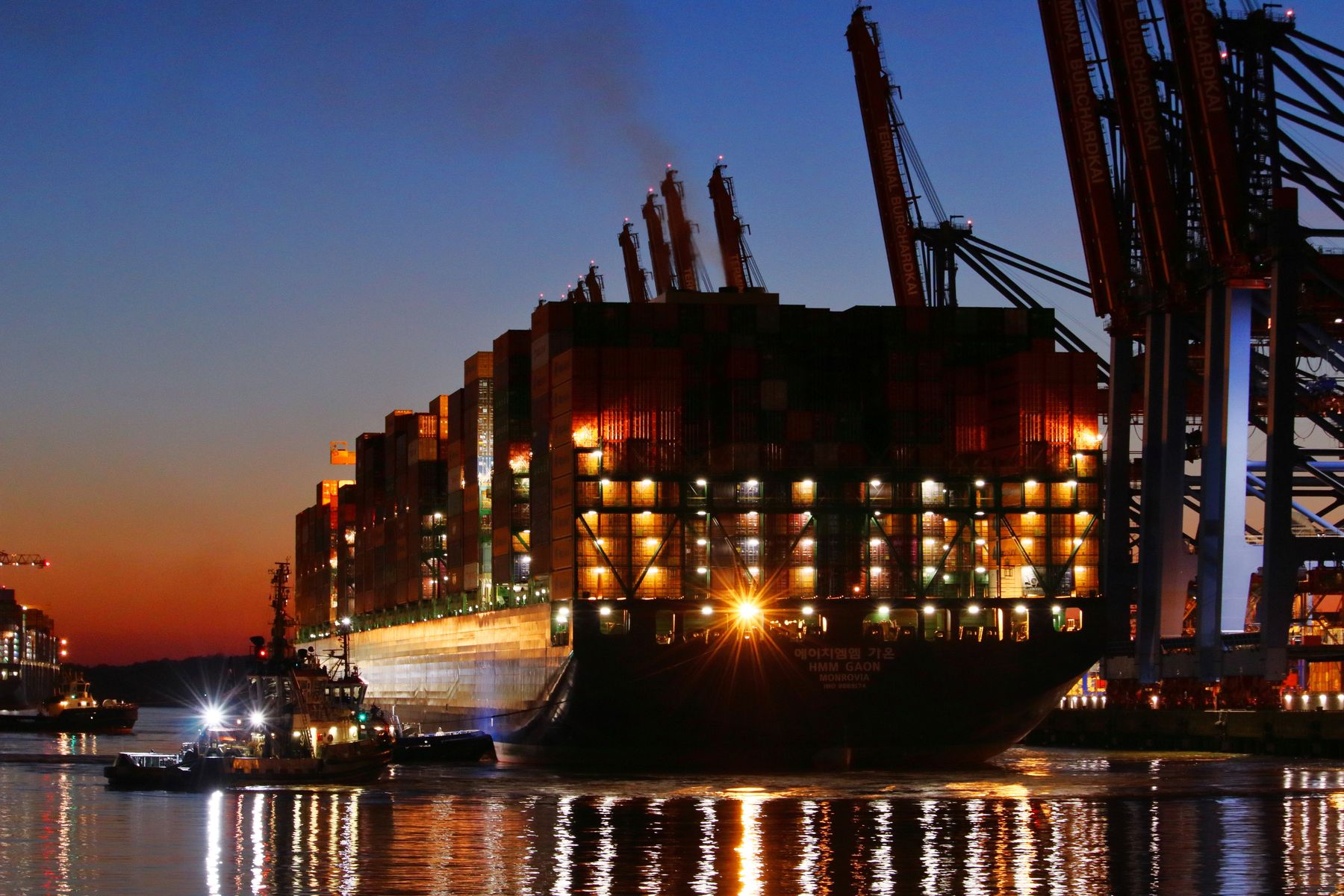 Container ship at port during sunset