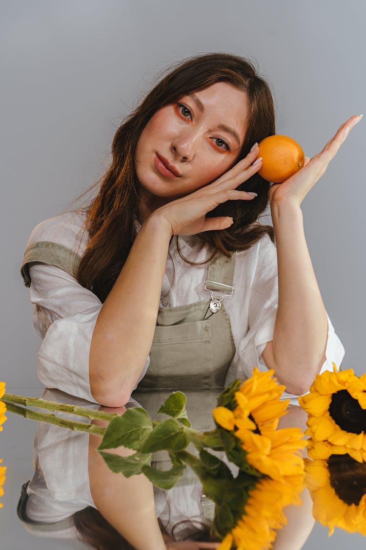 Portrait Of Woman With Orange And Flowers