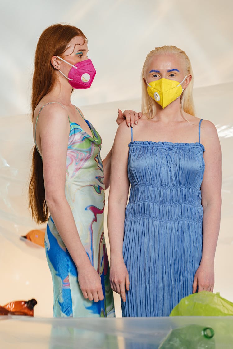 Women Wearing Facemasks Surrounded With Plastic Pollution